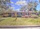 Charming single-story home with a well-maintained front yard and blooming azalea bushes at 1034 Ne 11Th St, Ocala, FL 34470