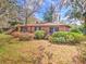 Landscaped front yard features lush greenery and vibrant pink azaleas around the charming home at 1034 Ne 11Th St, Ocala, FL 34470