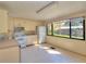 Bright kitchen features white appliances, tile flooring, and ample natural light at 1034 Ne 11Th St, Ocala, FL 34470