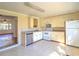 Bright kitchen features white appliances, tile flooring, and an open doorway at 1034 Ne 11Th St, Ocala, FL 34470