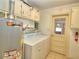 Functional laundry area with washer, dryer, and a water heater, offering convenience and storage at 1034 Ne 11Th St, Ocala, FL 34470