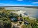 Lakeside houses with private docks amid green foliage against a tranquil lake backdrop at 10650 Se 101St Avenue Rd, Belleview, FL 34420