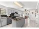 Bright kitchen with island, tile backsplash, view into dining area, and stainless steel dishwasher at 10650 Se 101St Avenue Rd, Belleview, FL 34420