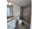 Bathroom with tiled shower, granite vanity, and modern fixtures at 107 Sw Alvarez Rd, Dunnellon, FL 34431