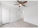 Bedroom features a ceiling fan, closet, and new flooring at 107 Sw Alvarez Rd, Dunnellon, FL 34431