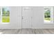 Bright entryway with white door, two windows, and wood-look flooring at 107 Sw Alvarez Rd, Dunnellon, FL 34431