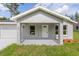 Inviting home exterior with a covered front porch, perfect for relaxing outdoors at 107 Sw Alvarez Rd, Dunnellon, FL 34431