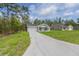 Property displaying a long driveway leading up to a charming home with an attached garage at 107 Sw Alvarez Rd, Dunnellon, FL 34431