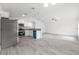 Bright, open kitchen with white cabinetry, granite countertops, and stainless steel appliances at 107 Sw Alvarez Rd, Dunnellon, FL 34431
