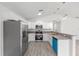 Well-lit kitchen features stainless appliances, granite countertops, and new flooring at 107 Sw Alvarez Rd, Dunnellon, FL 34431