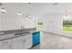Bright, open kitchen with granite countertops, stainless steel sink, and modern blue dishwasher at 107 Sw Alvarez Rd, Dunnellon, FL 34431