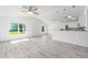 Bright open-concept home featuring gray flooring, high ceilings, and plentiful natural light at 107 Sw Alvarez Rd, Dunnellon, FL 34431