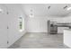 Open-concept living room featuring sleek floors, bright lighting, and neutral walls at 107 Sw Alvarez Rd, Dunnellon, FL 34431