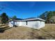 Back view of this delightful home, showcasing its well-manicured lot at 107 Sw Alvarez Rd, Dunnellon, FL 34431