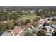 Aerial view of a home on a golf course with mature trees, and well-maintained landscaping at 11587 Sw 72Nd Cir, Ocala, FL 34476