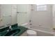 Well-lit bathroom with a green countertop sink, shower and a vanity at 11587 Sw 72Nd Cir, Ocala, FL 34476