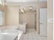 Bathroom with a large tub, a vanity with a sink, and a glass-door shower at 11587 Sw 72Nd Cir, Ocala, FL 34476
