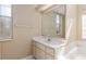 Bright bathroom featuring a sink and vanity near a tub and window at 11587 Sw 72Nd Cir, Ocala, FL 34476