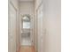 Hallway leading to bathroom with tub and natural light at 11587 Sw 72Nd Cir, Ocala, FL 34476