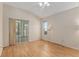 Bedroom featuring hardwood floors, a sliding glass door to the outside, a window, and neutral walls at 11587 Sw 72Nd Cir, Ocala, FL 34476