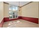 Open dining room with high ceiling, light fixture and large windows at 11587 Sw 72Nd Cir, Ocala, FL 34476