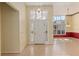 Bright foyer with wood floors, transom window and decorative light fixture at 11587 Sw 72Nd Cir, Ocala, FL 34476