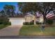 Charming single-story home featuring a well-manicured lawn and attached two-car garage at 11587 Sw 72Nd Cir, Ocala, FL 34476