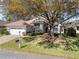 Charming home with lush landscaping, well-manicured lawn, and a welcoming entrance at 11587 Sw 72Nd Cir, Ocala, FL 34476