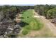 Scenic aerial view of a lush golf course with manicured greens, bunkers and tall trees at 11587 Sw 72Nd Cir, Ocala, FL 34476