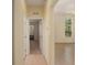 Hallway with white trim and natural light provides seamless access to other living spaces at 11587 Sw 72Nd Cir, Ocala, FL 34476