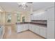 Open kitchen featuring white cabinets, tiled backsplash and stainless steel appliances at 11587 Sw 72Nd Cir, Ocala, FL 34476