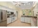 Bright kitchen with stainless steel appliances, white cabinetry and lots of counter space at 11587 Sw 72Nd Cir, Ocala, FL 34476