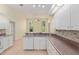 Bright kitchen featuring white cabinets, tiled backsplash and lots of counter space at 11587 Sw 72Nd Cir, Ocala, FL 34476