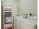 Functional laundry room with washer, dryer, and doorway to garage; practical and well-maintained at 11587 Sw 72Nd Cir, Ocala, FL 34476