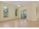 Sun-filled living room with hardwood floors, ceiling fan, and large windows at 11587 Sw 72Nd Cir, Ocala, FL 34476