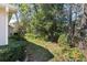 Well-maintained side yard with lush greenery and mature trees for privacy at 11587 Sw 72Nd Cir, Ocala, FL 34476