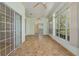 Large sunroom featuring tile floors, ceiling fans, and many windows providing natural light and outdoor views at 11587 Sw 72Nd Cir, Ocala, FL 34476