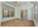 Bright sunroom featuring tile floors, large windows, and ceiling fan, offering serene views and natural light at 11587 Sw 72Nd Cir, Ocala, FL 34476