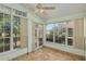 Bright sunroom features tiled flooring, and wall-to-wall windows at 11587 Sw 72Nd Cir, Ocala, FL 34476