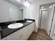 Bright bathroom with double sink vanity, black granite countertop, and walk-in shower at 13042 Sw 60Th Court Rd, Ocala, FL 34473