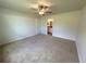Comfortable bedroom with plush carpeting and a view to the attached bathroom at 13042 Sw 60Th Court Rd, Ocala, FL 34473