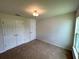 Spacious bedroom featuring carpet flooring and natural light at 13042 Sw 60Th Court Rd, Ocala, FL 34473