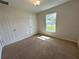 Bedroom with a large window and carpet flooring at 13042 Sw 60Th Court Rd, Ocala, FL 34473