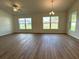 Bright and airy living room boasting wood-look floors and large windows at 13042 Sw 60Th Court Rd, Ocala, FL 34473