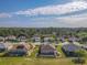 Neighborhood view featuring manicured lawns, screened-in pools, and beautiful landscaping at 13128 Se 97Th Terrace Rd, Summerfield, FL 34491