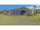 A well-maintained backyard features a screened-in pool and meticulously landscaped surroundings at 13128 Se 97Th Terrace Rd, Summerfield, FL 34491