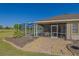 Landscaped backyard features a screened-in pool, covered patio, and golf course views, perfect for outdoor living at 13128 Se 97Th Terrace Rd, Summerfield, FL 34491