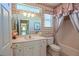 Bathroom featuring a vanity with a large mirror, bathtub, and wallpaper at 13128 Se 97Th Terrace Rd, Summerfield, FL 34491