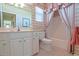 Quaint bathroom features a tub with shower, tile flooring, a marble countertop vanity, and floral wallpaper at 13128 Se 97Th Terrace Rd, Summerfield, FL 34491