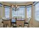 Dining area with a chandelier and large windows at 13128 Se 97Th Terrace Rd, Summerfield, FL 34491
